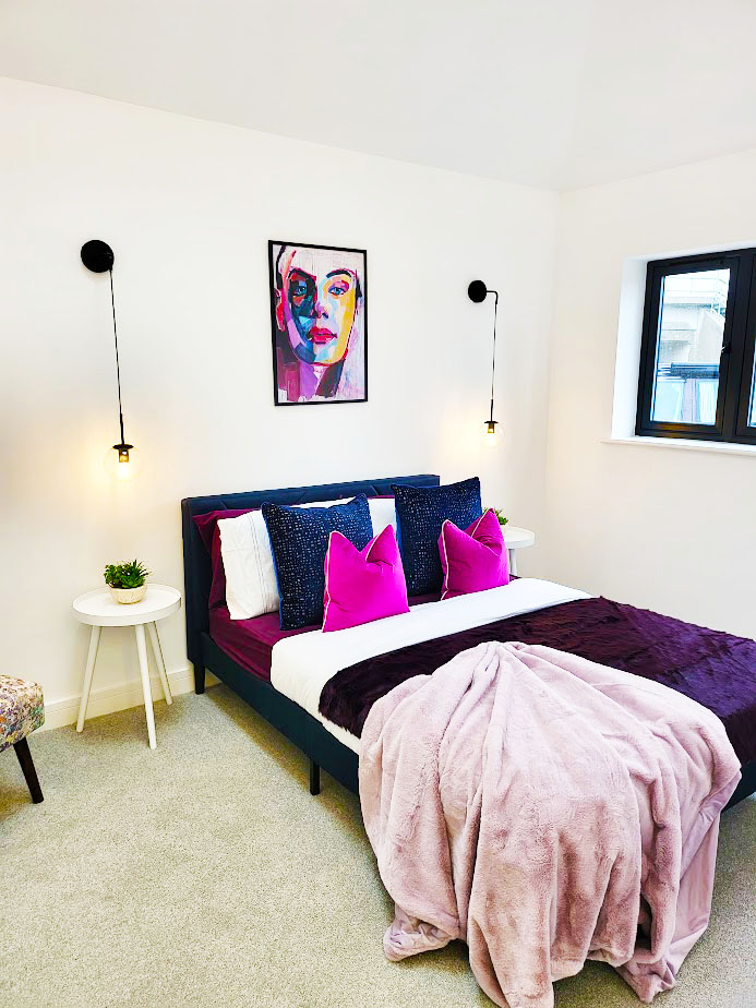 Marketing Strategy for Estate Agents. Using Home Staging as a marketing tool. 
After Home Staging Bedroom in new build property
Pendant side lights with double bed with purple and pink accent cushions and purple fur throw