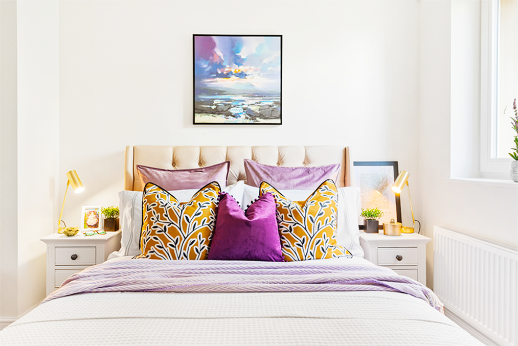 Bedroom made up of Purples and Golds dressed for Home Staging