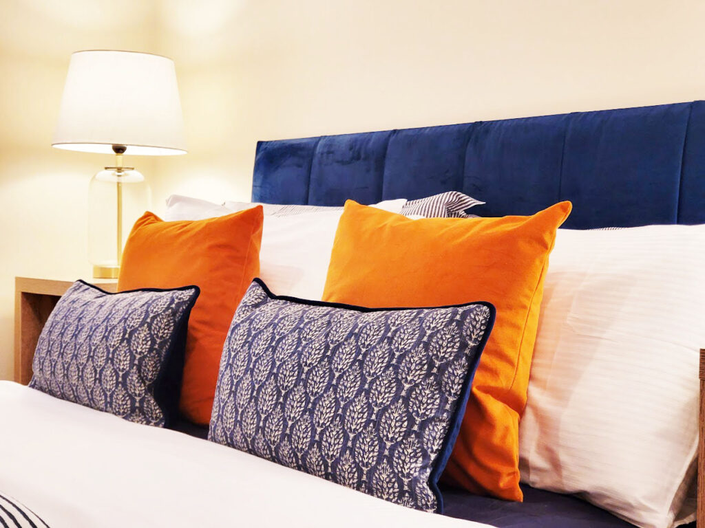 Bedroom image of a vacant apartment after home staging utilising uk sized double bed and headboard