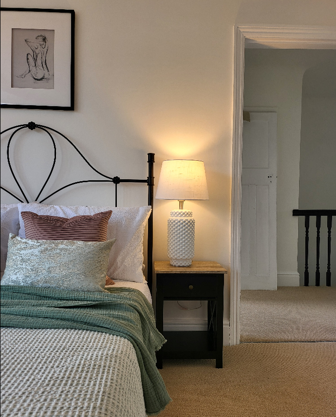 Guest bedroom lifestyle with doorway and stairwell behind