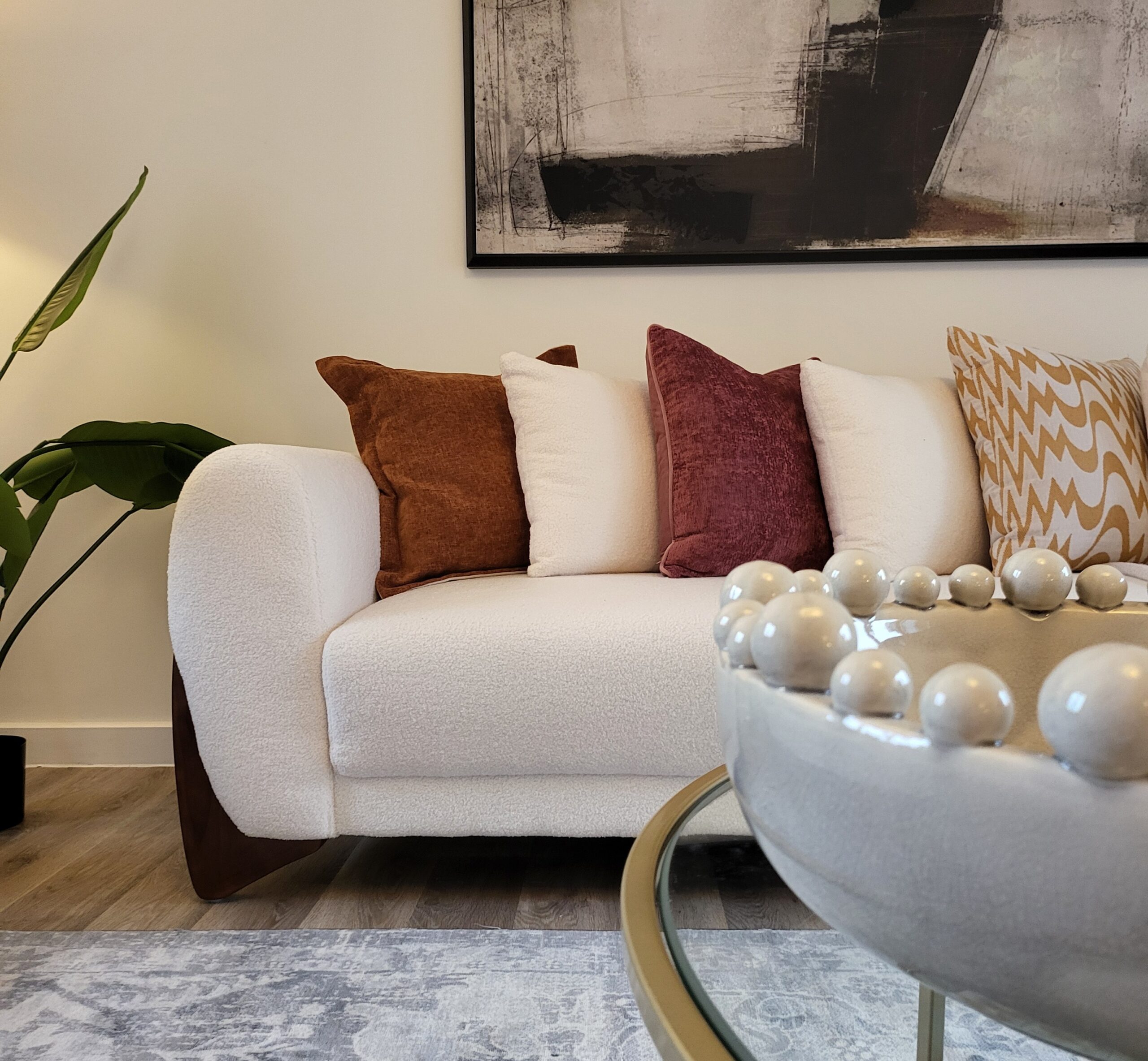 Boucle Sofa in Living Room with grounded earthy tones with greens and burnt orange